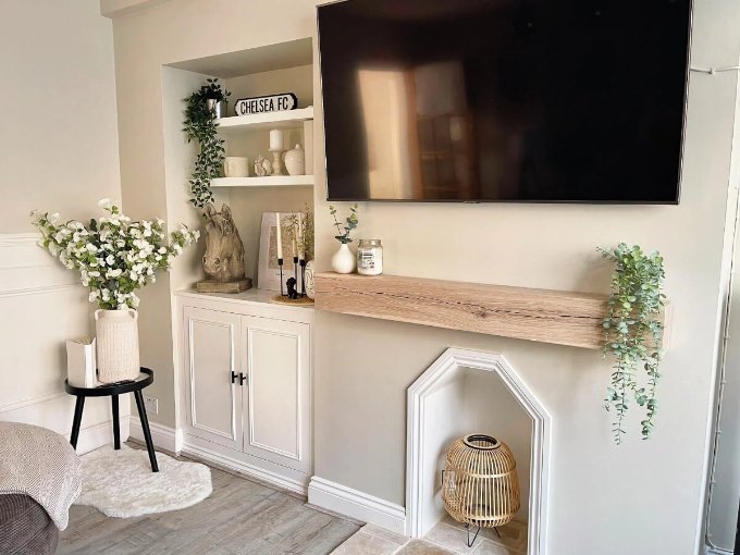 Oak beam above a media wall with a television mounted above