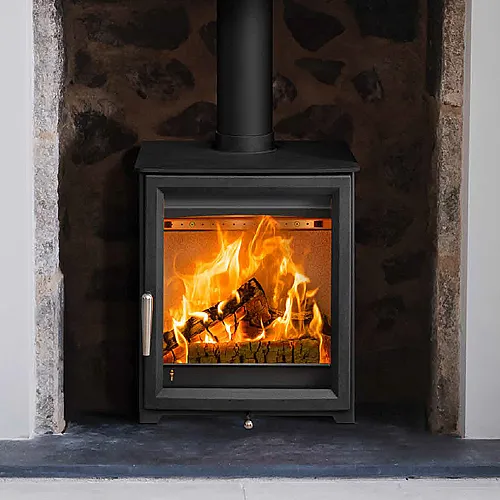The Hunter Isca 5 wood burning stove lit within the recessed feature wall