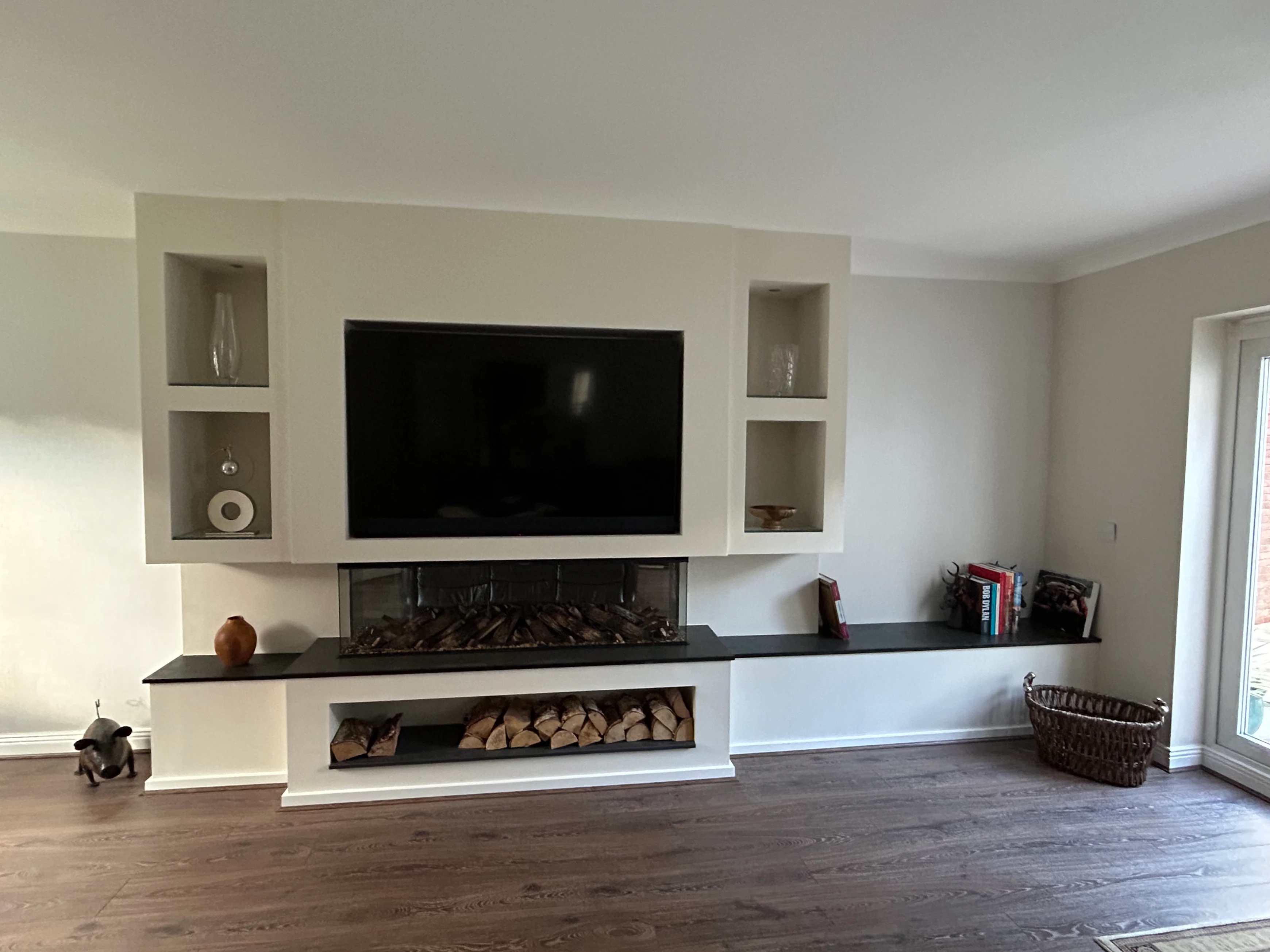The finished media wall with electric fire, slate shelves and log storage