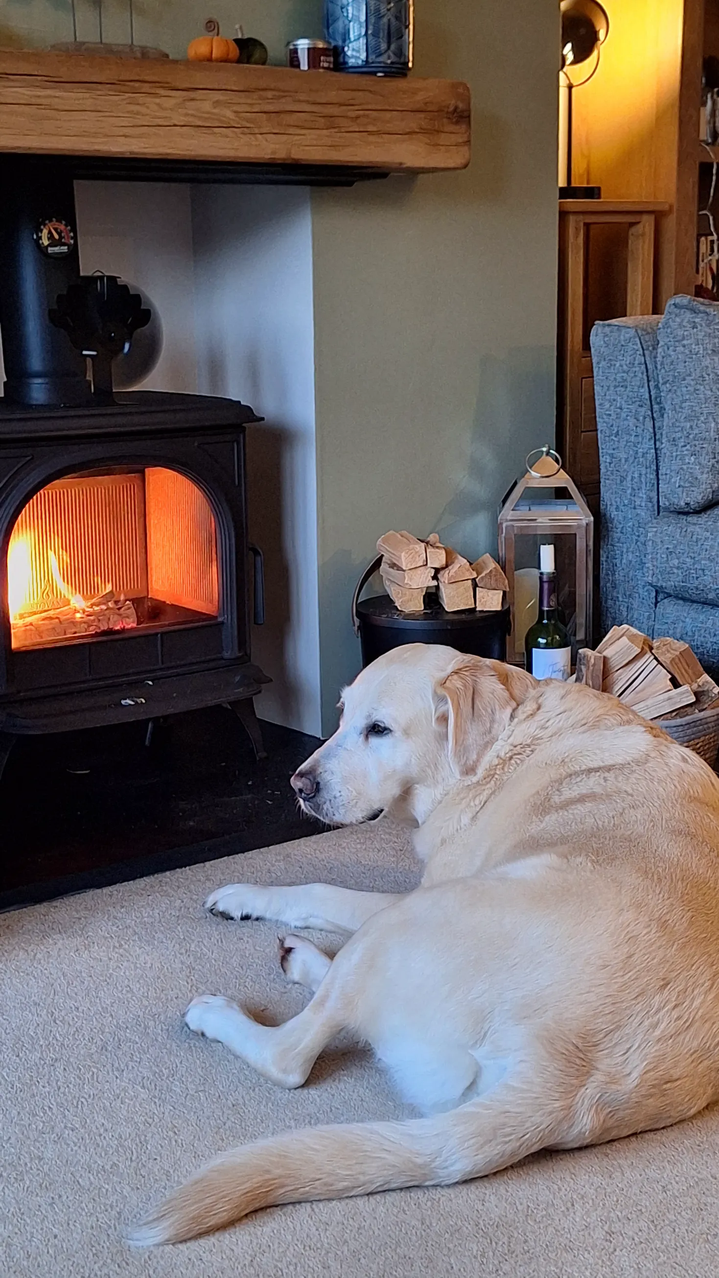The finished wood burning stove installation with oak beam mantel