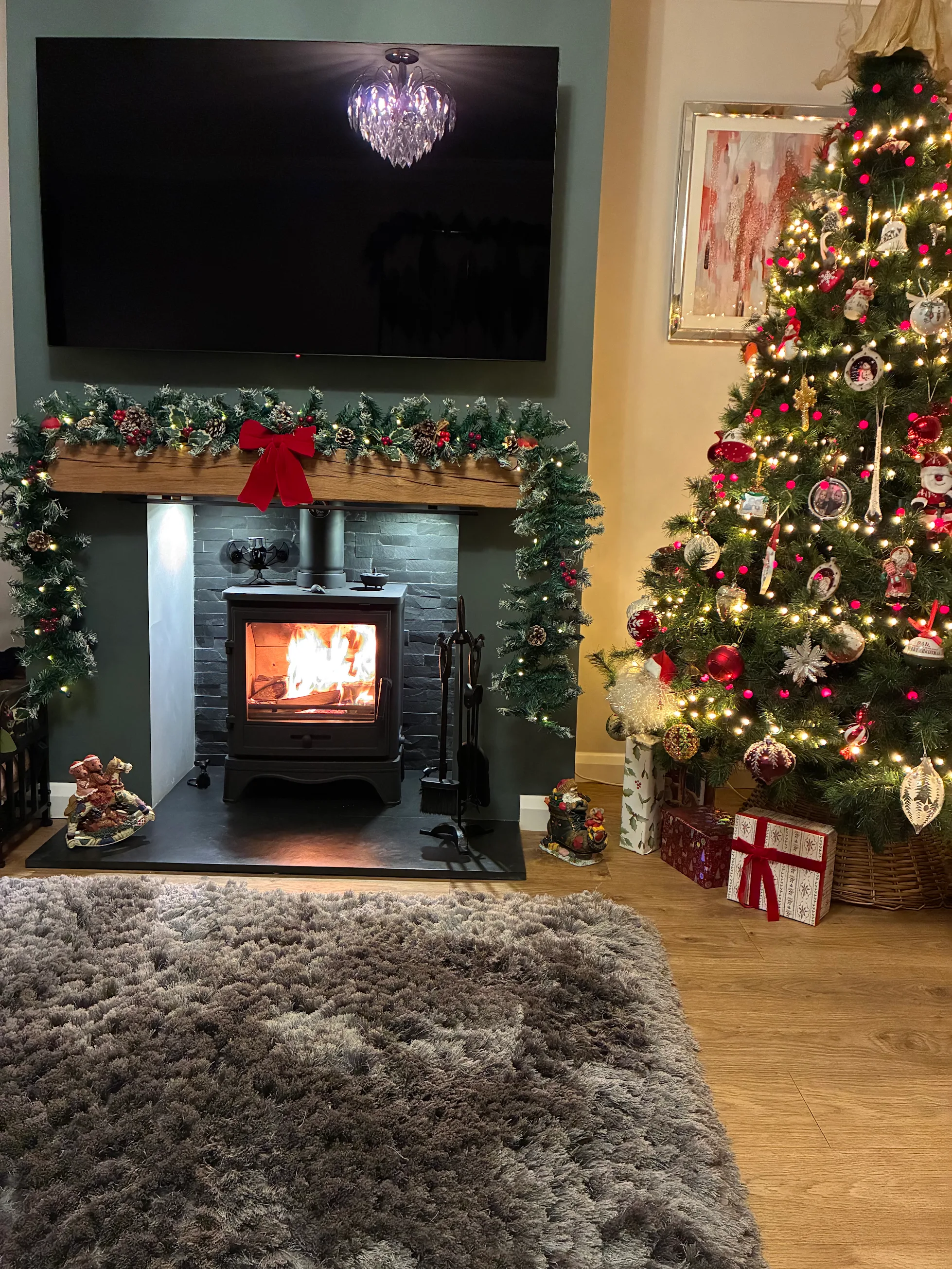The finished wood burning stove installation with a split-slate chamber and oak beam