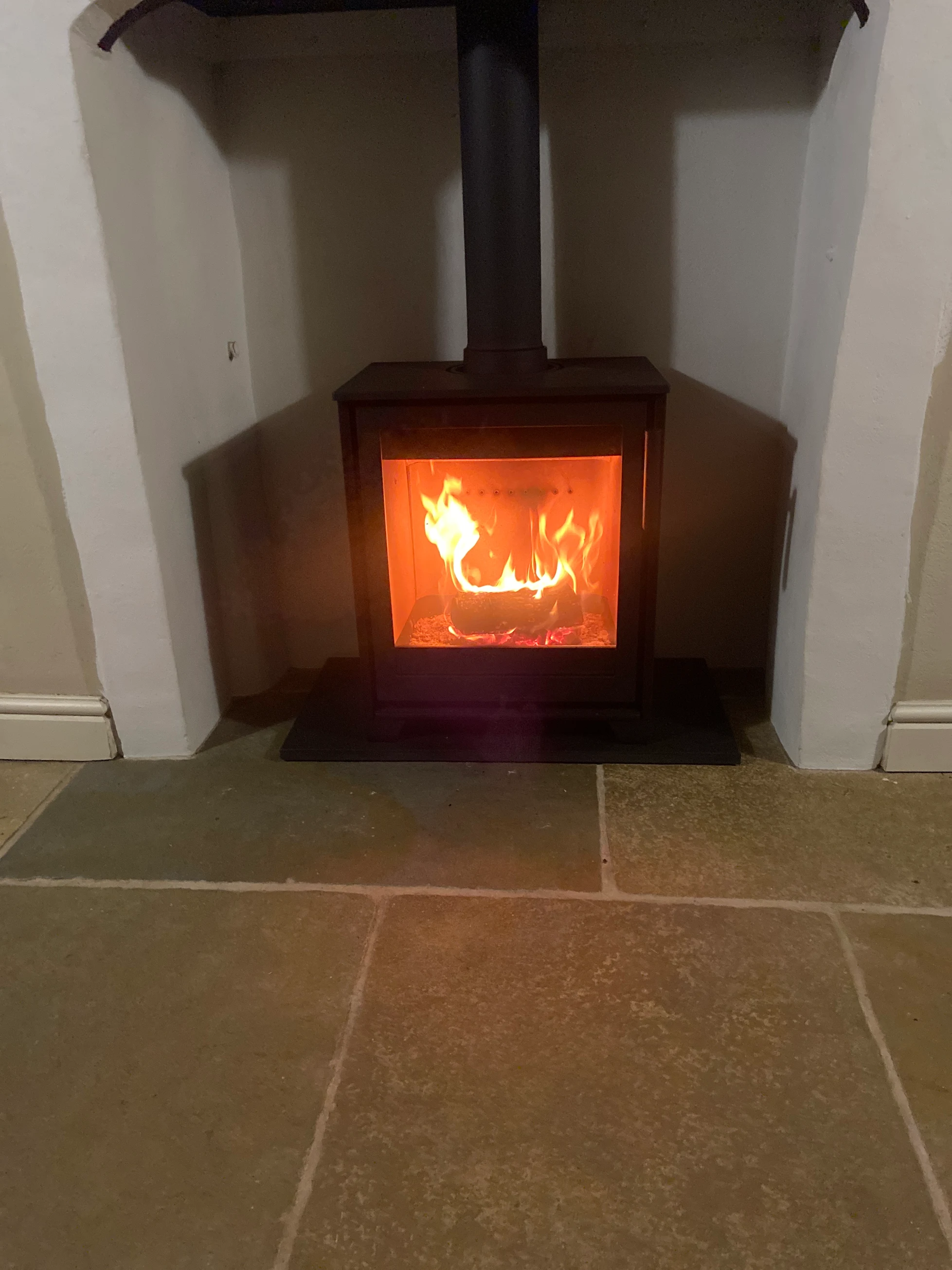 A 5kW Contura wood burning stove fitted with a solid oak beam mantel