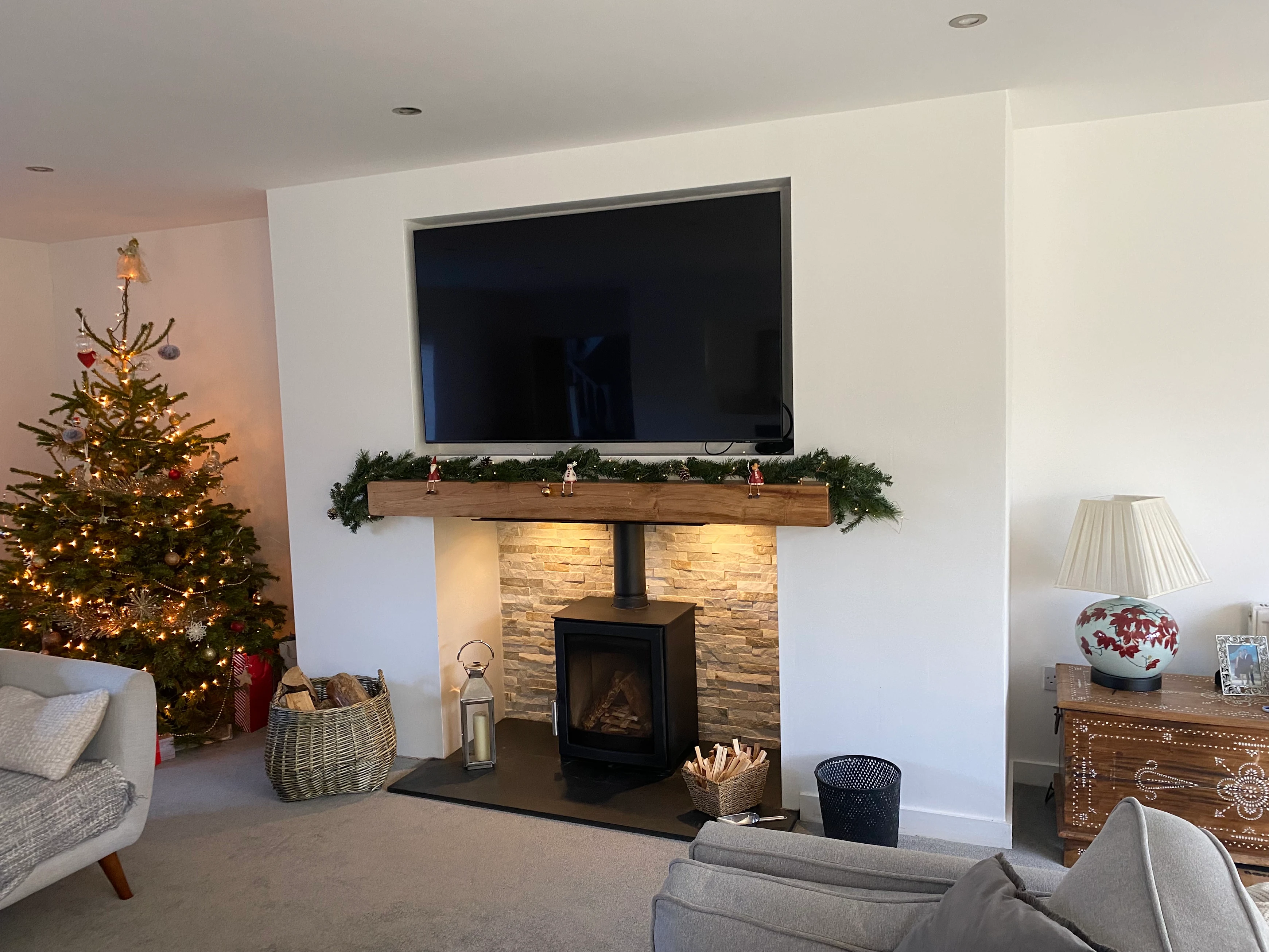 A built fireplace with a new wood burning stove installed as the focal point of the room