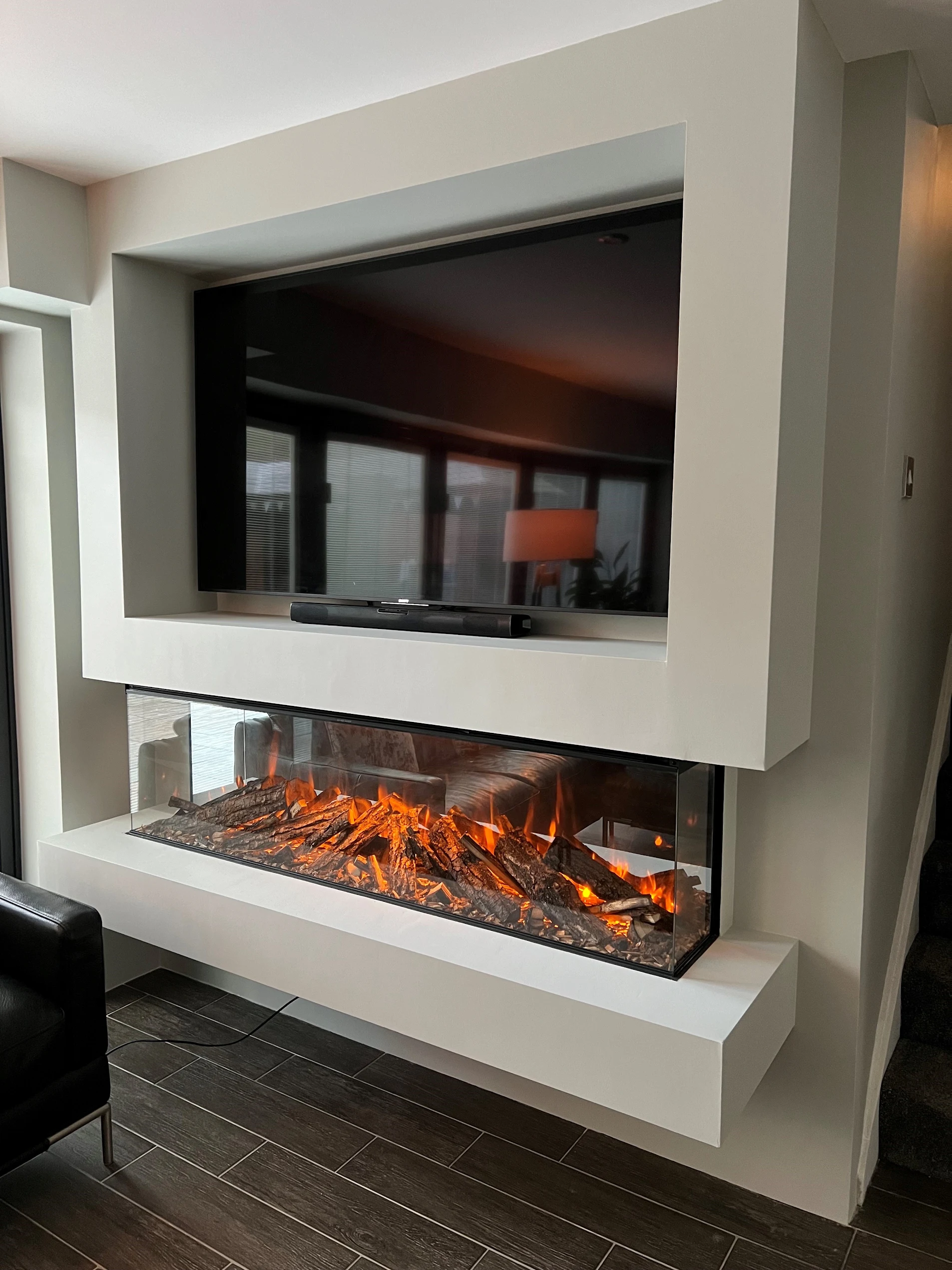 A media wall with an inset electric fire by The Fireplace & Stove Co.