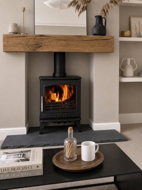 Old mill aged black limestone hearth shown in a completed fireplace setting