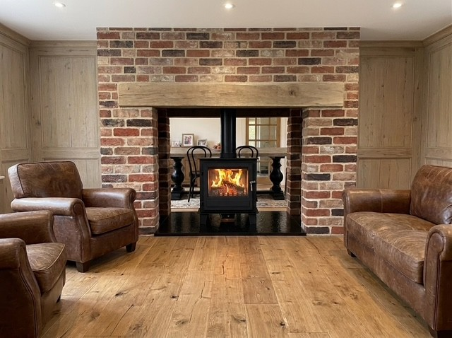 Clock Blithfield DS viewed through a brick fireplace opening between two rooms