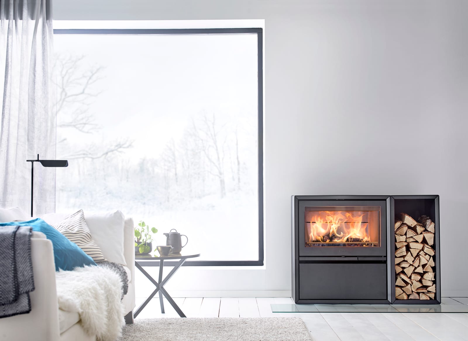 Contura 310 wood burning stove in a room setting with log box