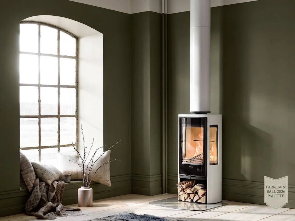 White Contura 856G Style woodburning stove in an olive-green living room