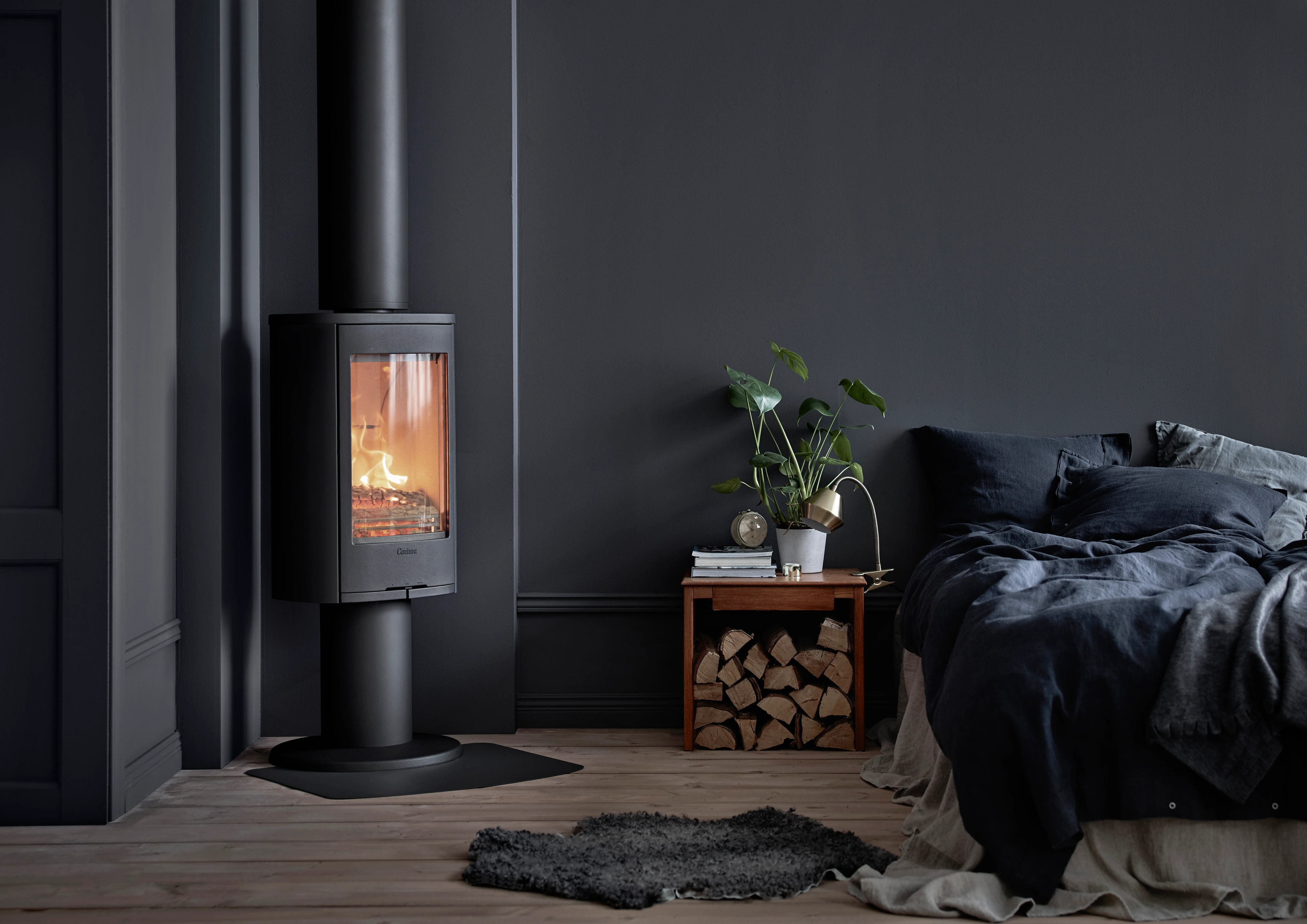Contura 870 Style wood burning stove in a manufacturer room set