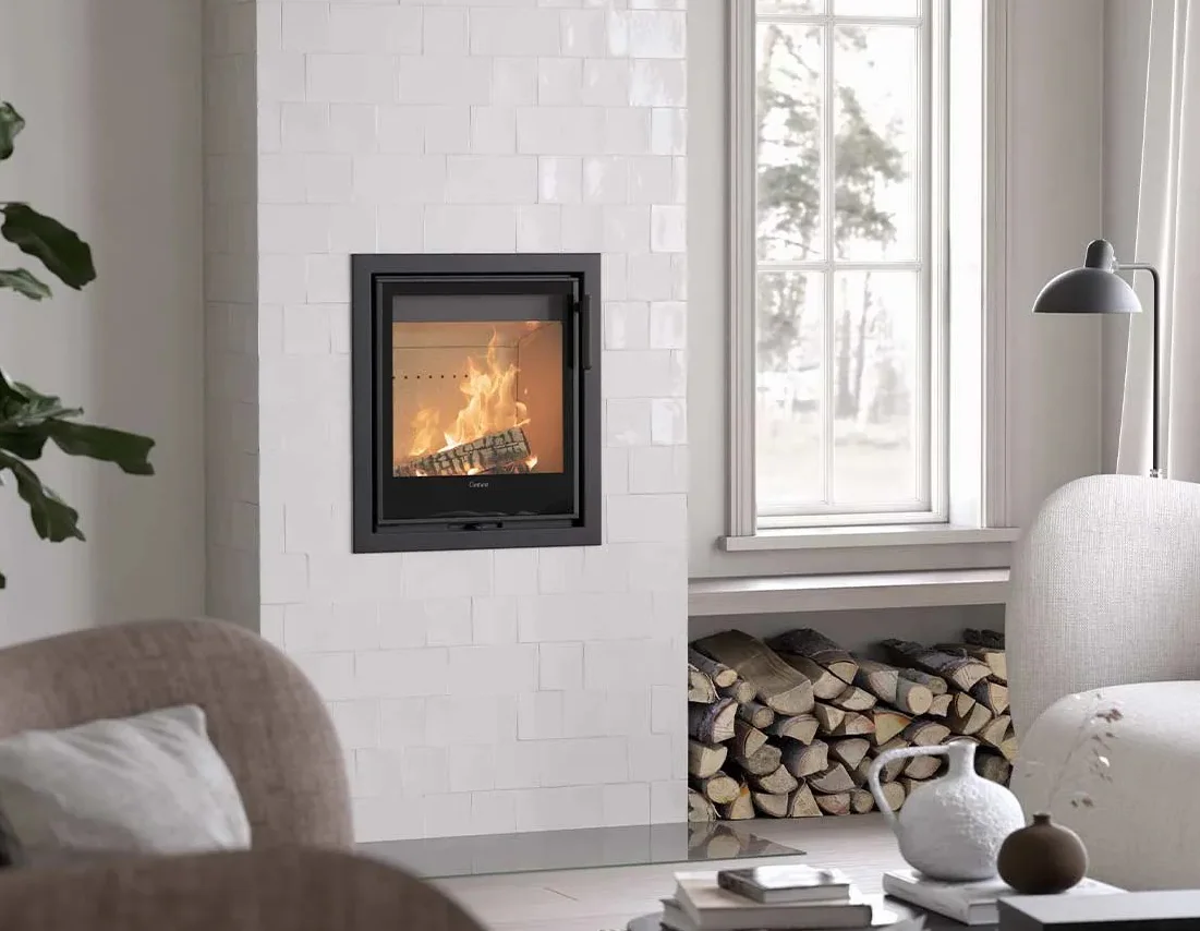 Contura i2 cassette stove raised within a white tiled fireplace wall