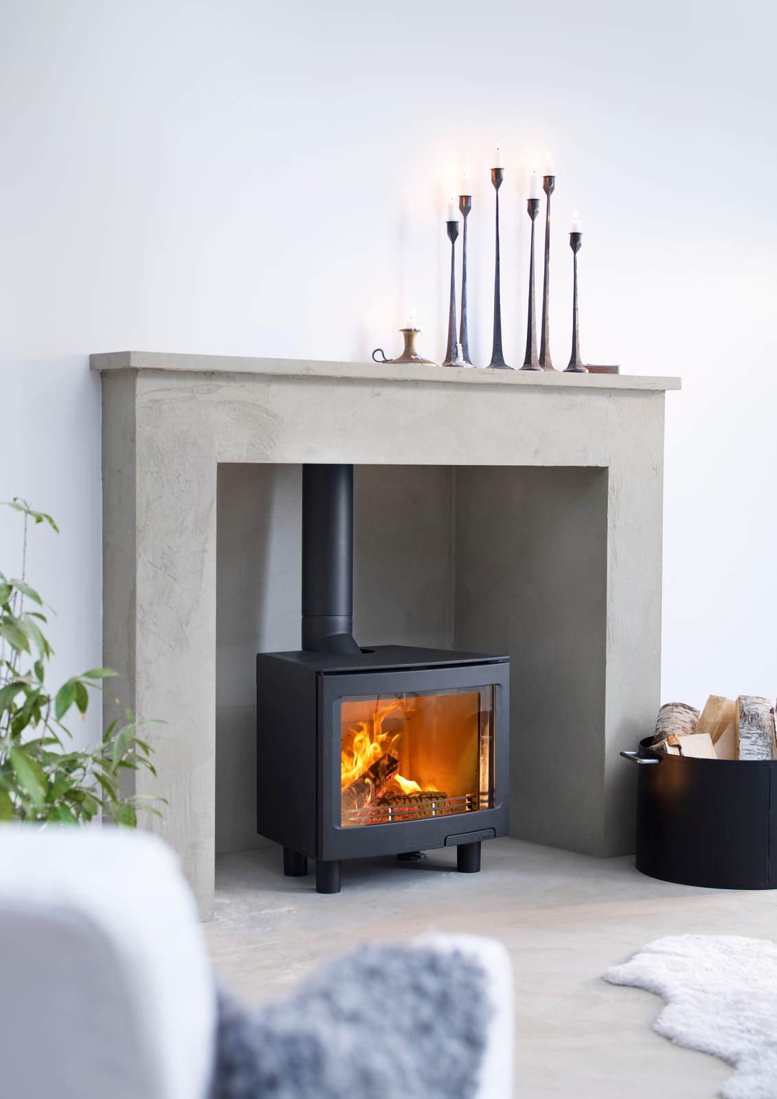 Contura i5L inset wood burning stove in a fireplace room setting