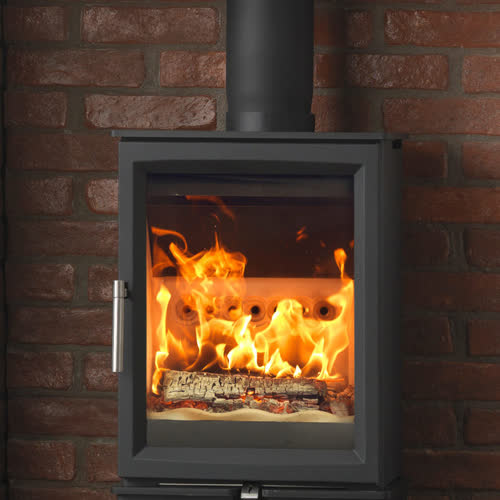 Fireline Woodtec 5 wood burning stove in a fireplace setting